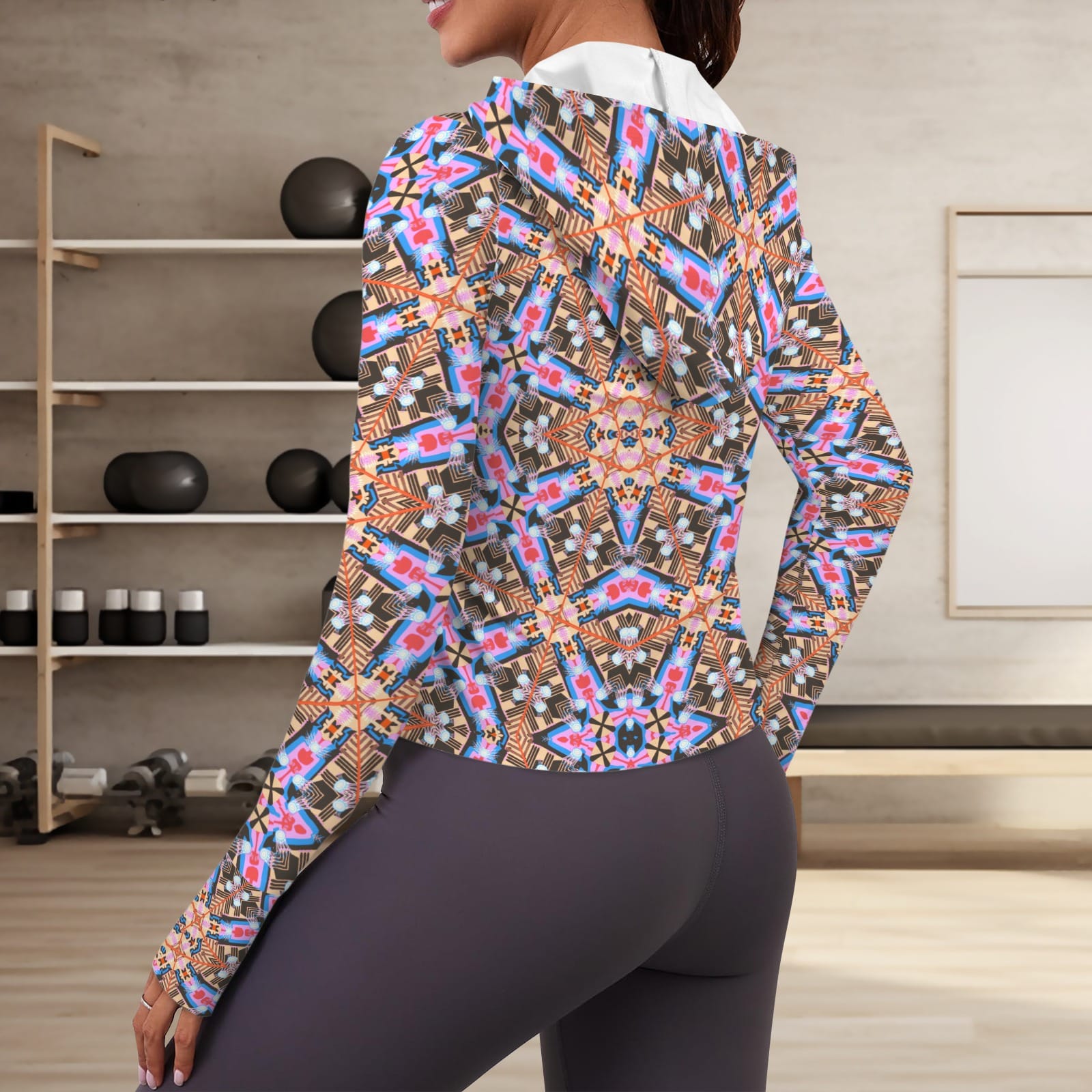 Over-the-shoulder rear view of a woman wearing the fitted, geometric print hooded activewear jacket paired with dark grey yoga leggings in a modern home gym setup.ded Performance Jacket with Thumbholes
