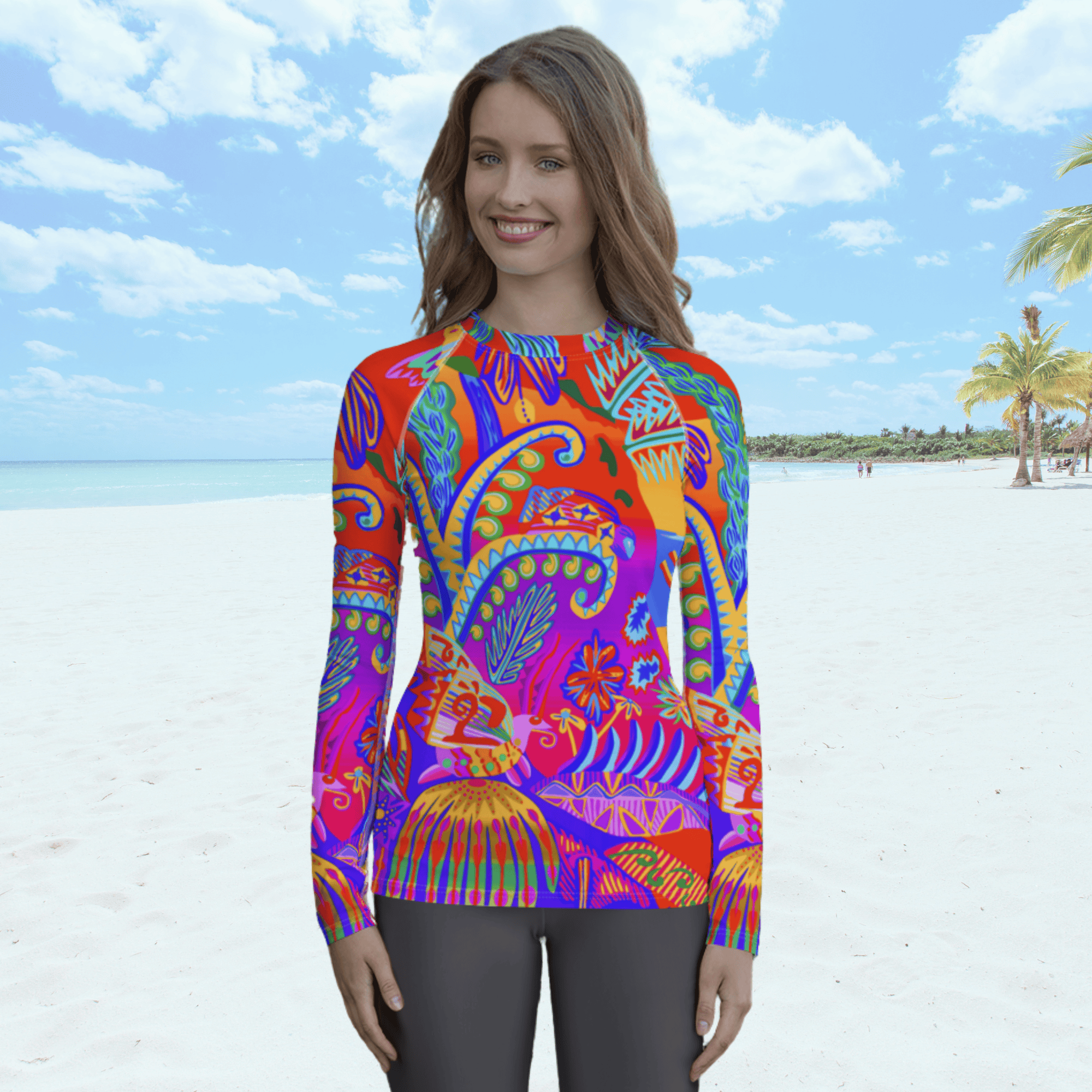 A long-sleeved rash guard top with a vibrant, colorful tropical scene with insects. The top features a red base with blue, orange, purple, and yellow floral and abstract patterns. The top is worn by a white female standing on a beach.