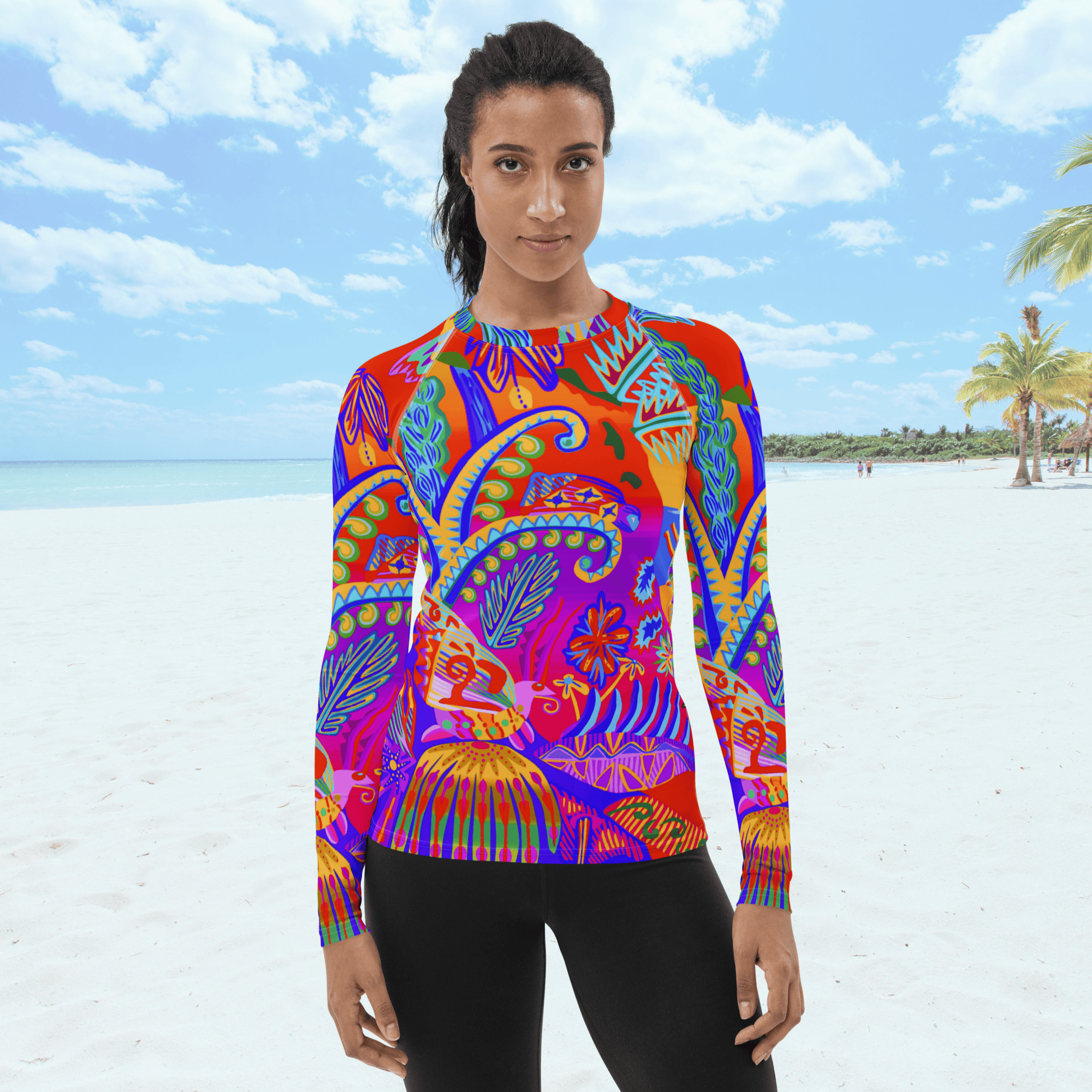 A long-sleeved rash guard top with a vibrant, colorful tropical scene with insects. The top features a red base with blue, orange, purple, and yellow floral and abstract patterns. The top is worn by a black female standing on a beach.