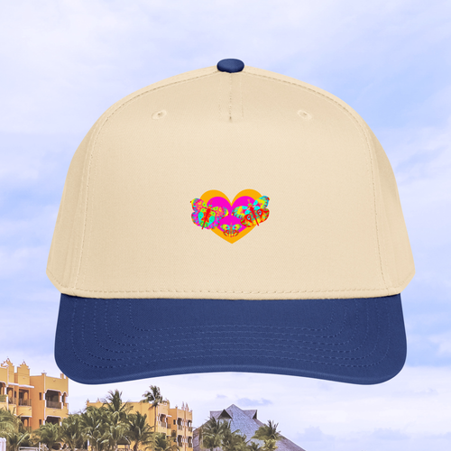 Beige cap with blue brim featuring a colorful butterfly heart design against a blurred background of buildings and trees.