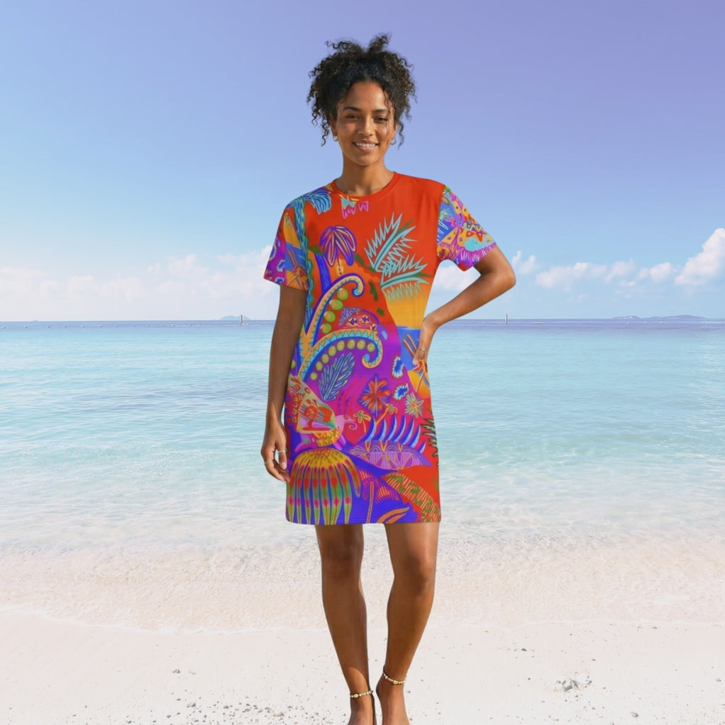 Movie of black woman with curly hair walking on a beach. She is wearing the vibrant tropical t-shirt dress. 
