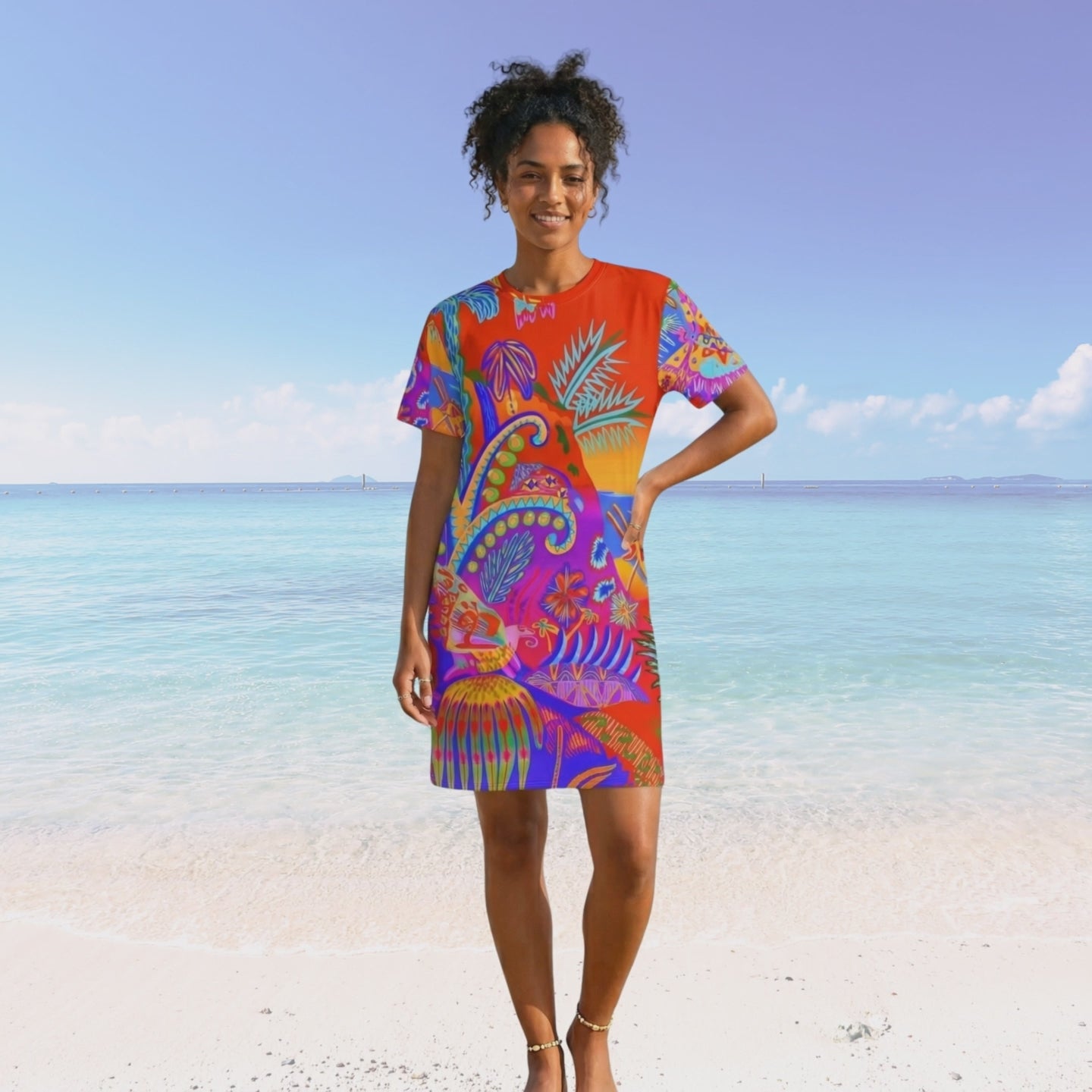 Movie of black woman with curly hair walking on a beach. She is wearing the vibrant tropical t-shirt dress. 